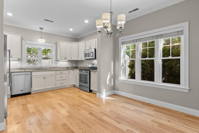4 Emerald Way Unit 4, Salisbury, MA 01952 - kitchen featuring stainless steel appliances, ornamental molding, plenty of natural light, light wood-style floors, and white cabinetry