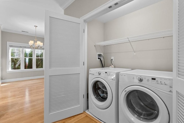 4 Emerald Way Unit 4, Salisbury, MA 01952 - laundry area with washer and dryer, a chandelier, light wood finished floors, and ornamental molding