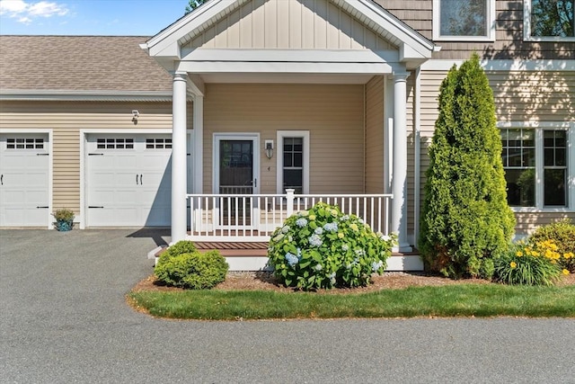 4 Emerald Way Unit 4, Salisbury, MA 01952 - doorway to property with a garage, a porch, asphalt driveway, board and batten siding, and roof with shingles