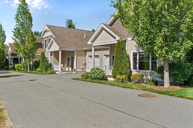 4 Emerald Way Unit 4, Salisbury, MA 01952 - view of front of property featuring a porch, board and batten siding, roof with shingles, and a garage