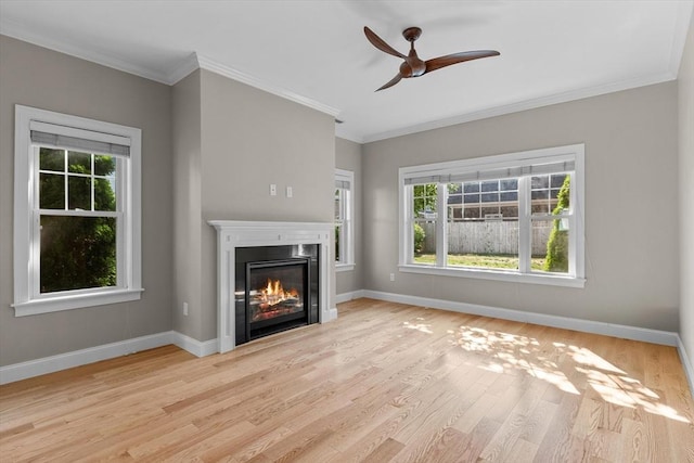 4 Emerald Way Unit 4, Salisbury, MA 01952 - unfurnished living room featuring plenty of natural light, wood finished floors, ceiling fan, a glass covered fireplace, and ornamental molding