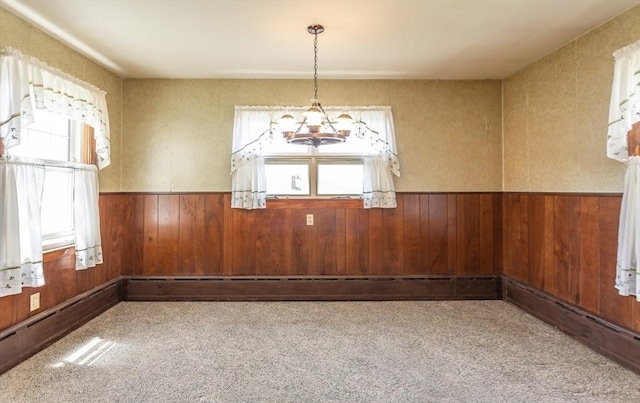 195 Hooper St, Tiverton, RI 02878 - carpeted empty room with wood walls, a chandelier, and a wainscoted wall