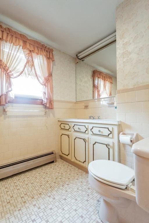 195 Hooper St, Tiverton, RI 02878 - half bathroom with toilet, vanity, a baseboard heating unit, tile walls, and wallpapered walls
