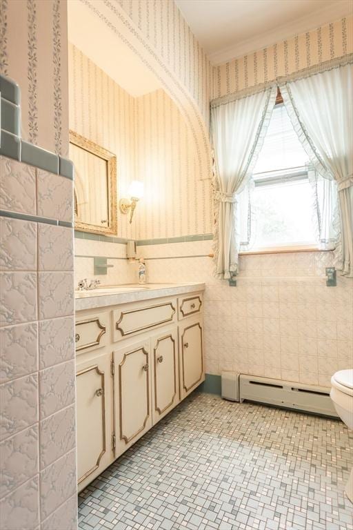 195 Hooper St, Tiverton, RI 02878 - bathroom with a baseboard heating unit, vanity, wallpapered walls, toilet, and tile walls