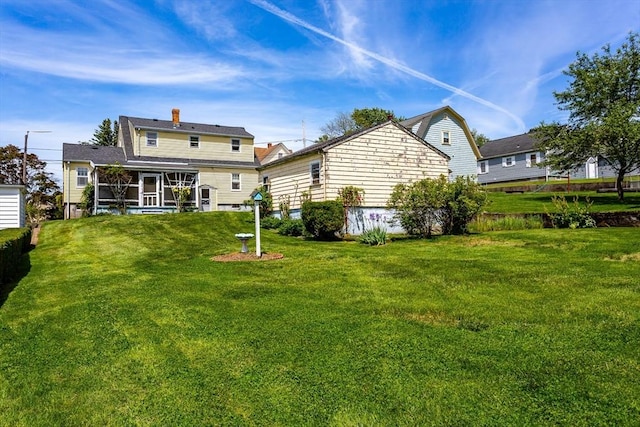 195 Hooper St, Tiverton, RI 02878 - rear view of house featuring a sunroom, a lawn, and a chimney