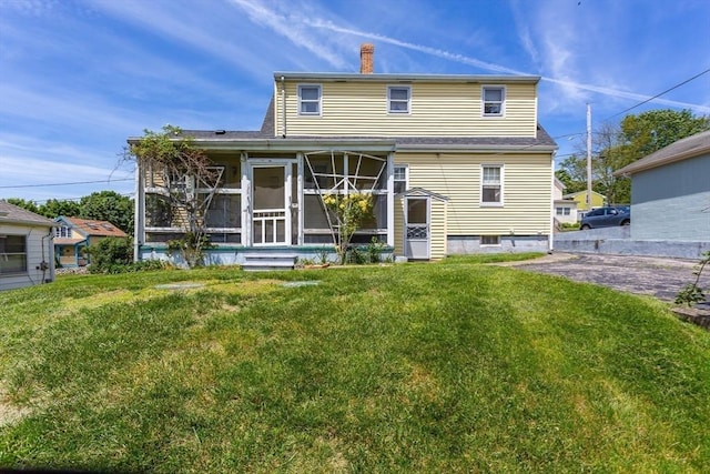 195 Hooper St, Tiverton, RI 02878 - rear view of house with a sunroom, a chimney, and a lawn