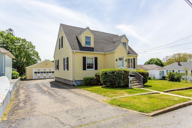 195 Hooper St, Tiverton, RI 02878 - new england style home with an outbuilding, a garage, a shingled roof, and a front lawn