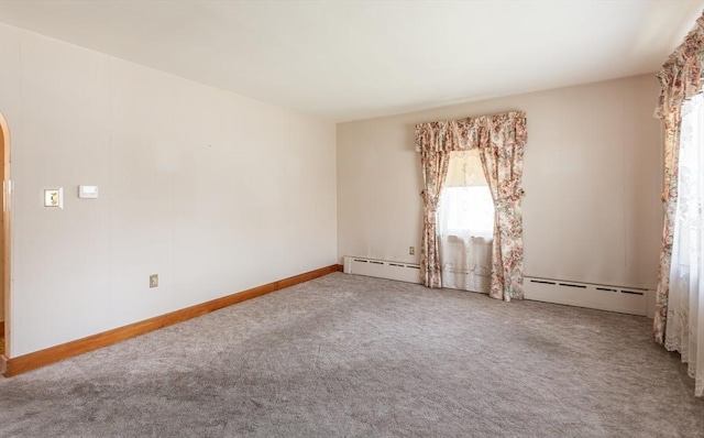 195 Hooper St, Tiverton, RI 02878 - carpeted empty room with a baseboard radiator, arched walkways, and baseboards