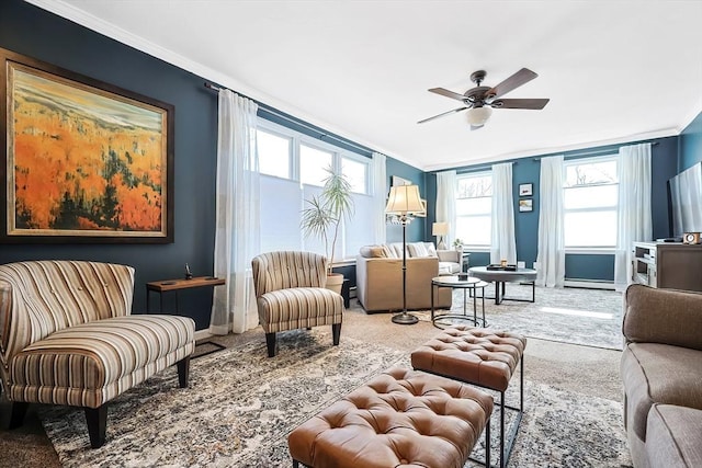 carpeted living room with baseboards, ceiling fan, and ornamental molding