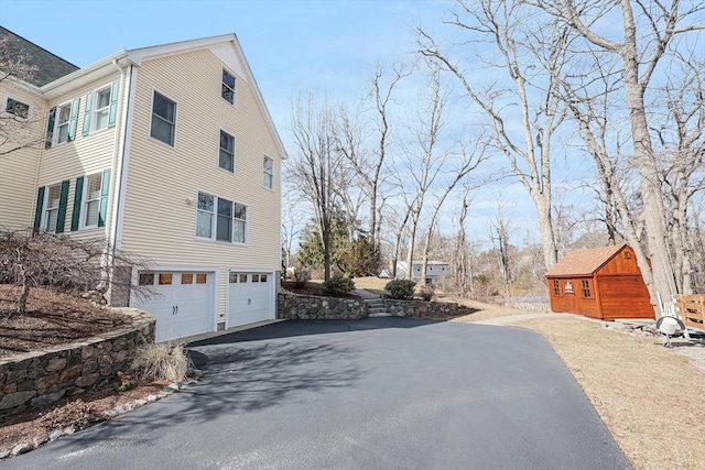 view of side of property with an attached garage and driveway