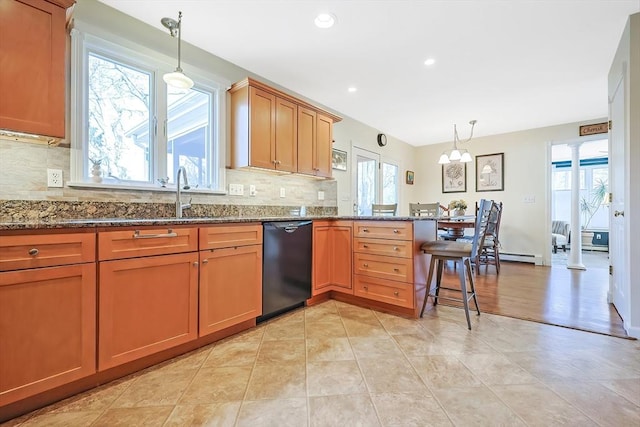 kitchen with dishwasher, dark stone counters, decorative backsplash, a peninsula, and a sink