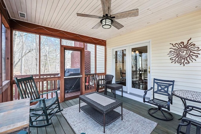 sunroom with visible vents, wood ceiling, and a ceiling fan