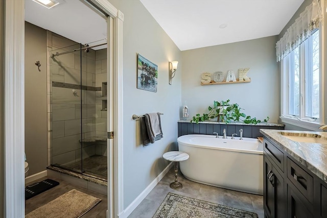 full bathroom featuring toilet, baseboards, a stall shower, and a freestanding bath