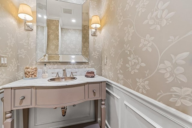 bathroom featuring wallpapered walls, visible vents, and vanity