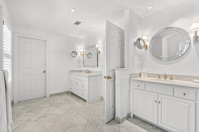 full bath with visible vents, two vanities, a sink, and recessed lighting