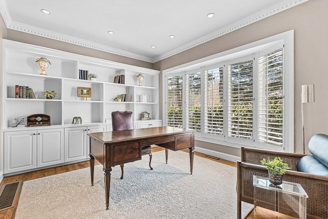 office with ornamental molding, wood finished floors, visible vents, and recessed lighting