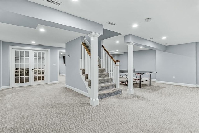 below grade area featuring baseboards, stairs, visible vents, and carpet flooring