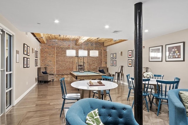 dining space with visible vents, beam ceiling, brick wall, baseboards, and wooden ceiling