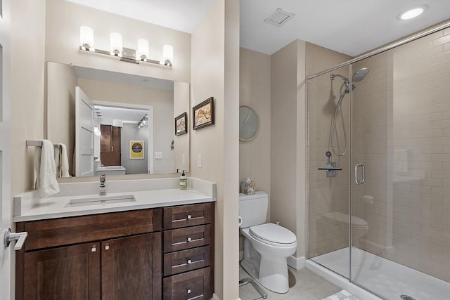 full bath with vanity, toilet, tile patterned floors, visible vents, and a stall shower