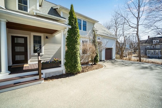 view of front of home with a porch and a garage