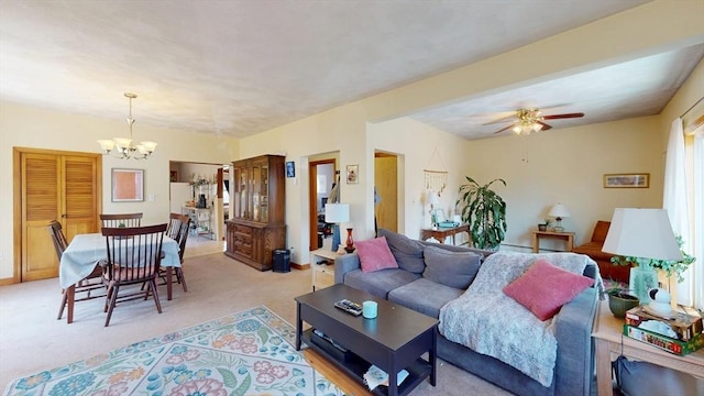 living room featuring a chandelier, light colored carpet, and a ceiling fan