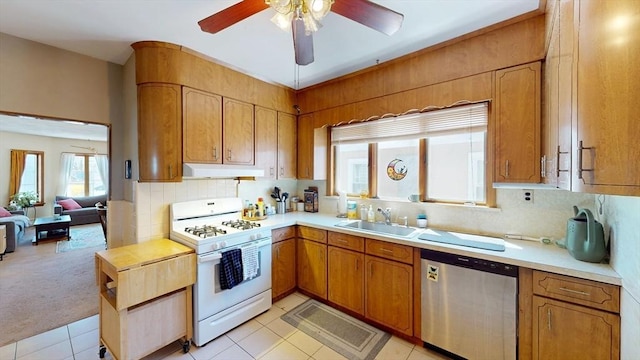kitchen featuring white range with gas stovetop, dishwasher, a sink, ceiling fan, and backsplash