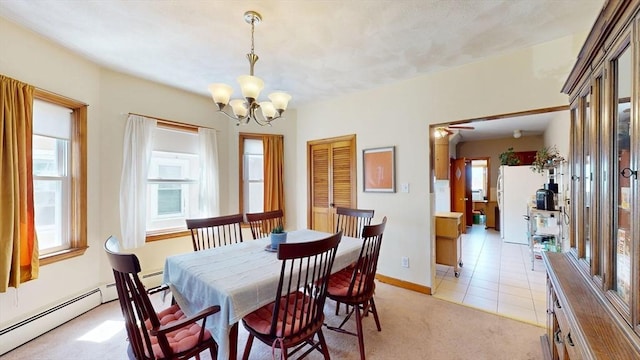 dining space featuring healthy amount of natural light, a chandelier, light colored carpet, and baseboard heating