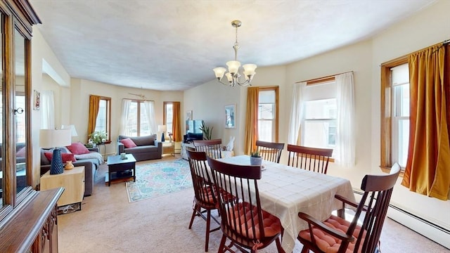 dining room featuring light colored carpet, a chandelier, and a baseboard heating unit