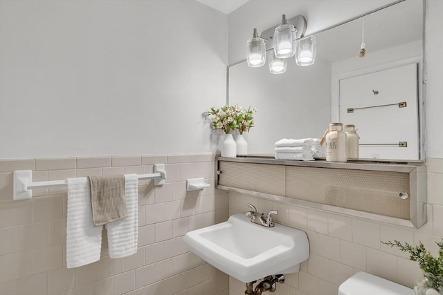 bathroom with sink and tile walls