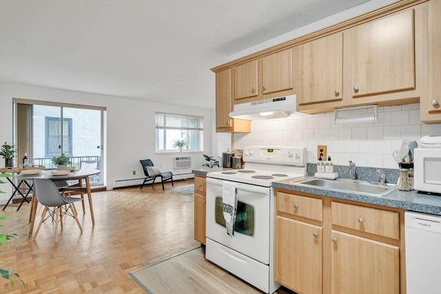 kitchen featuring light brown cabinetry, sink, a baseboard radiator, and white appliances