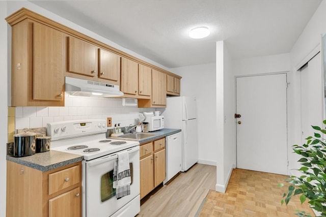 kitchen featuring sink, white appliances, backsplash, and light brown cabinets