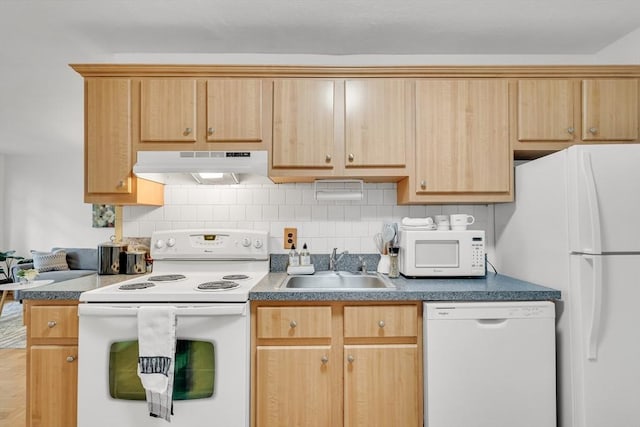 kitchen featuring sink, light brown cabinetry, and white appliances