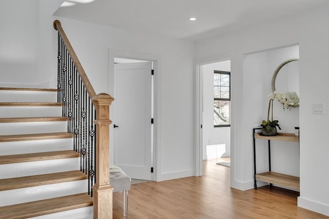 stairs with hardwood / wood-style flooring