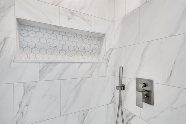 interior details featuring a tile shower