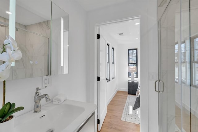 bathroom with vanity, hardwood / wood-style flooring, and an enclosed shower