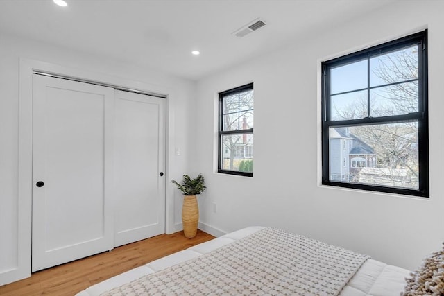 bedroom featuring a closet and light hardwood / wood-style flooring