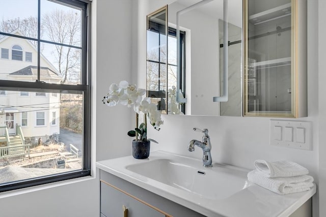 bathroom featuring a healthy amount of sunlight and vanity