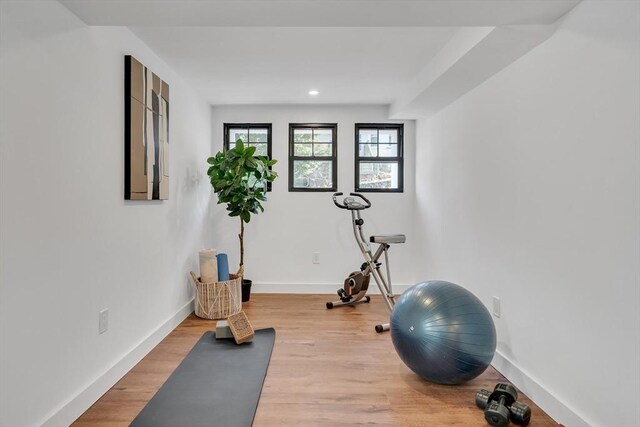 workout room with light hardwood / wood-style floors