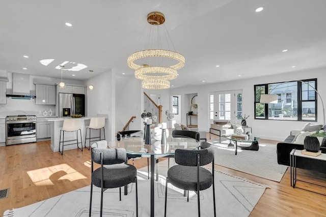 dining area with a chandelier and light hardwood / wood-style floors