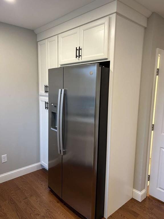 kitchen with white cabinetry, stainless steel fridge, and dark hardwood / wood-style flooring