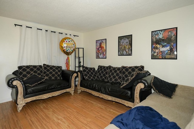25 Sutherland St, Lowell, MA 01850 - living area with wood finished floors and a textured ceiling