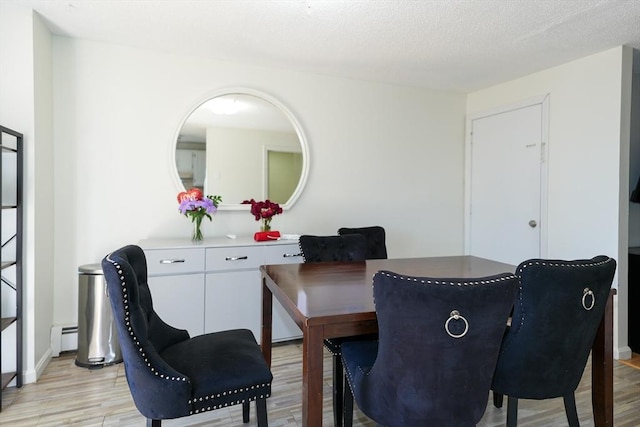 25 Sutherland St, Lowell, MA 01850 - dining room with light wood finished floors and a baseboard radiator