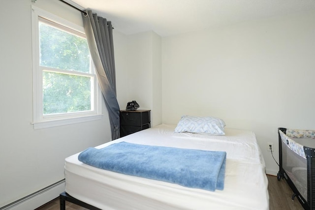 25 Sutherland St, Lowell, MA 01850 - bedroom featuring multiple windows, wood finished floors, and a baseboard radiator