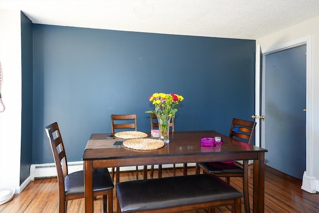25 Sutherland St, Lowell, MA 01850 - dining room with wood finished floors and a baseboard radiator