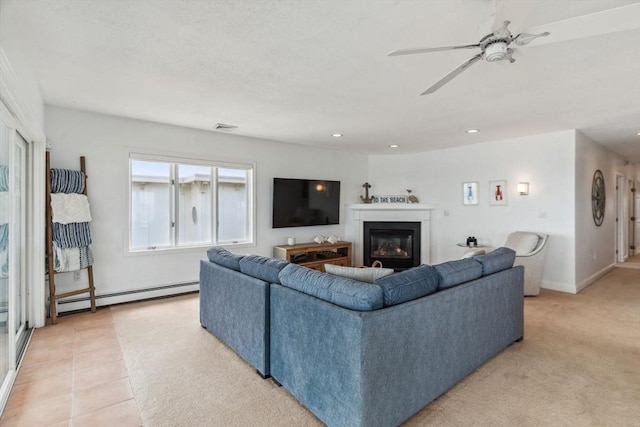 living room featuring a baseboard heating unit, a glass covered fireplace, ceiling fan, recessed lighting, and baseboards