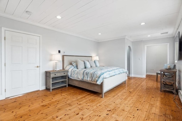 bedroom featuring arched walkways, recessed lighting, light wood-style flooring, crown molding, and baseboards