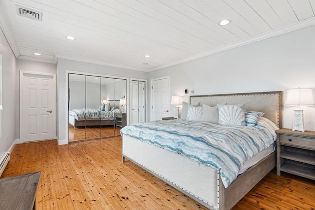 bedroom with light wood-style flooring, crown molding, multiple closets, recessed lighting, and baseboards