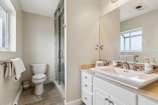 bathroom with toilet, baseboards, a shower stall, and vanity