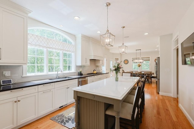 kitchen featuring a sink, stainless steel appliances, plenty of natural light, and recessed lighting
