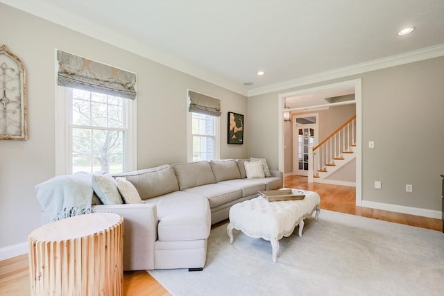 living area featuring crown molding, light wood-style floors, baseboards, stairs, and recessed lighting